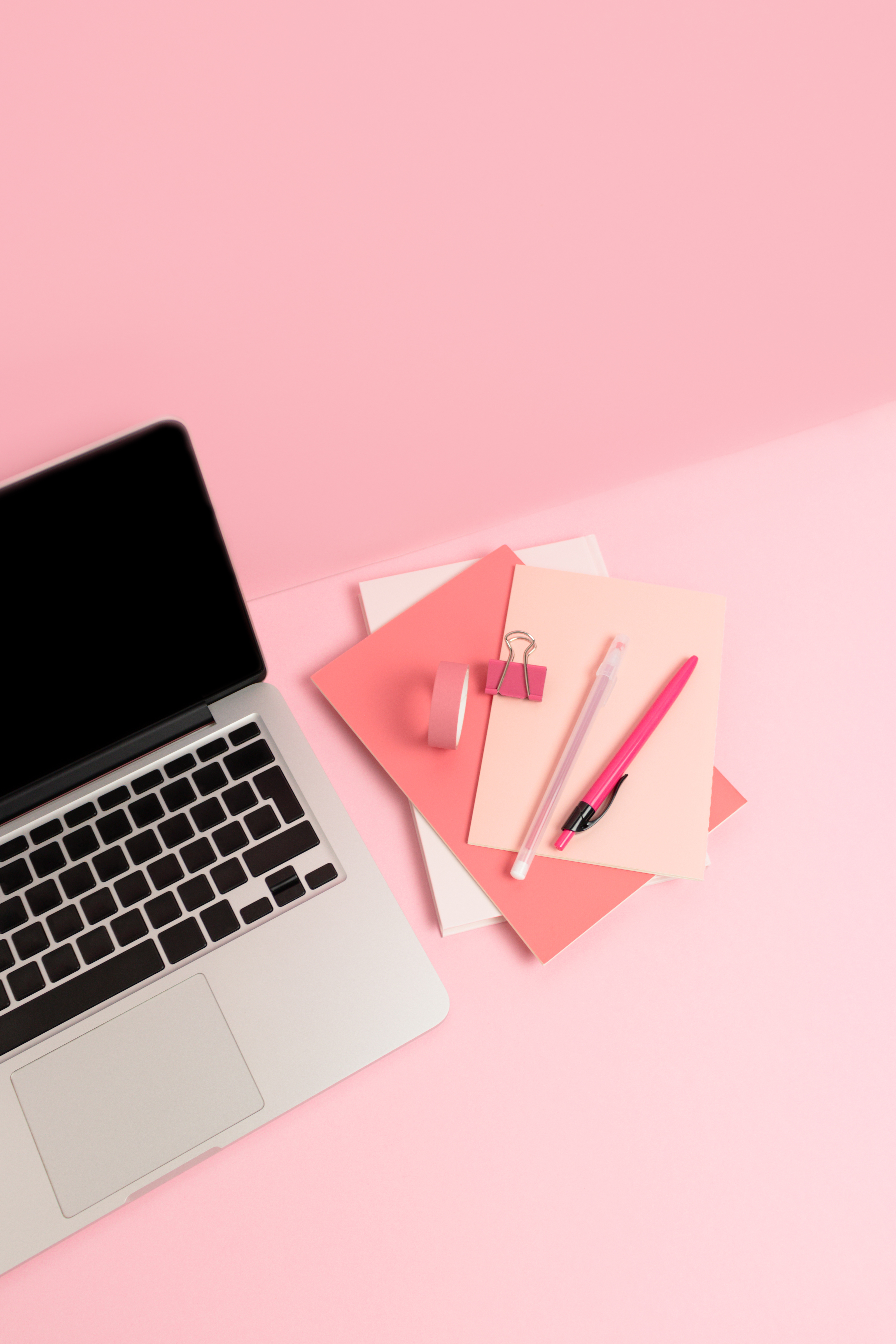 Laptop and Office Supplies on Pink Background     